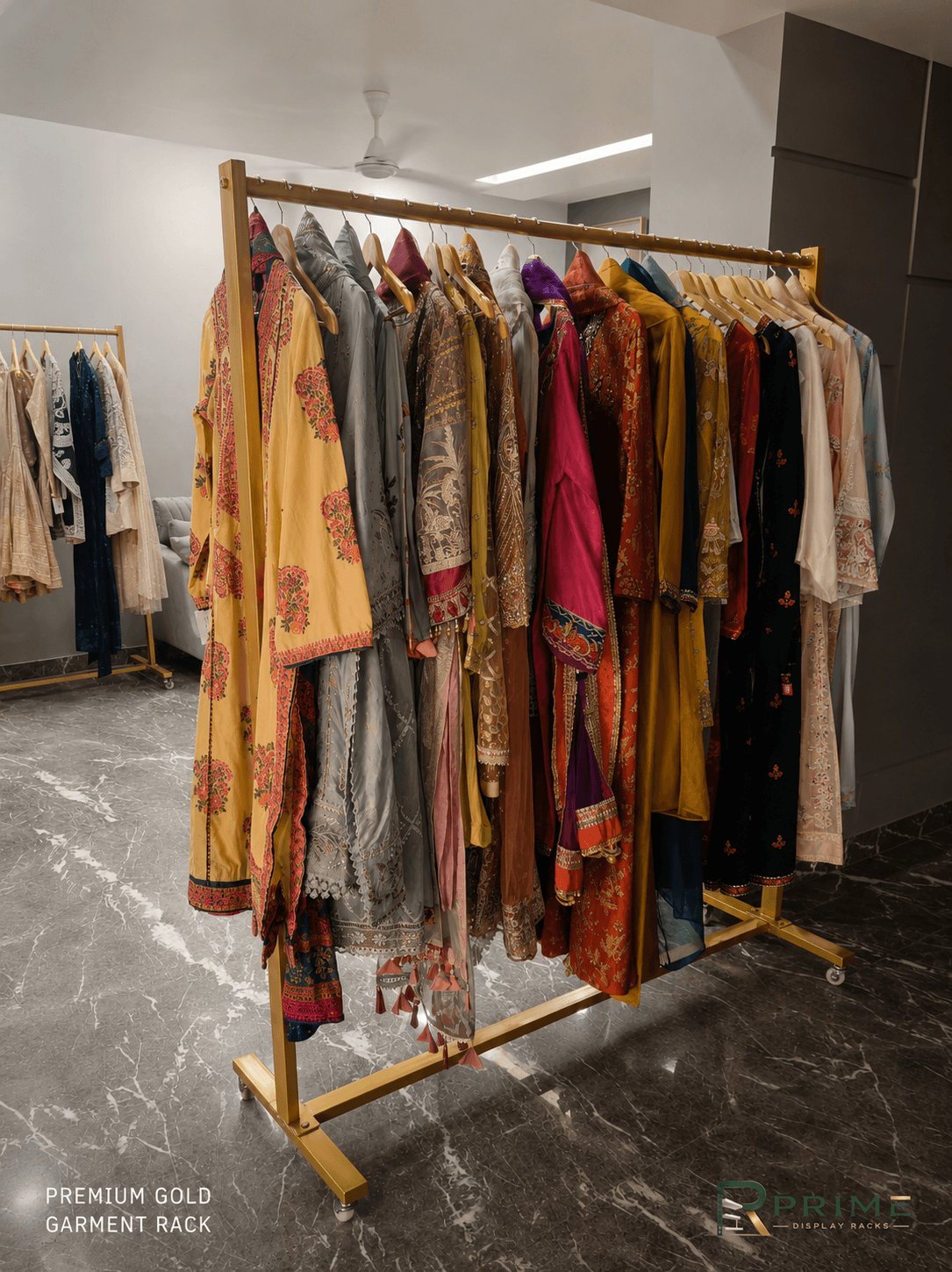 Premium gold garment rack displaying ethnic wear in a boutique — Prime Display Racks Delhi NCR